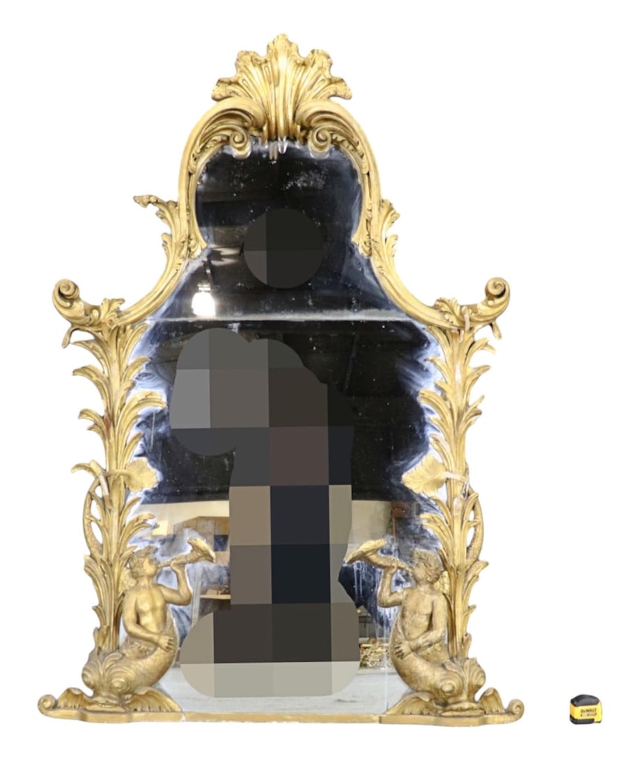 HEAVILY CARVED GILTWOOD LARGE FIGURAL MIRROR: Heavily carved. Giltwood. Figural. 72 1/2" h x 49" w x 6" d.