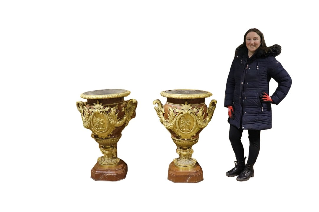 PAIR PALACE SIZE ROUGE MARBLE HEAVILY BRONZE MOUNTED URNS: Bronze mounted. Rouge marble. 38 1/4" h x 27 1/4" w x 22 1/2" d.