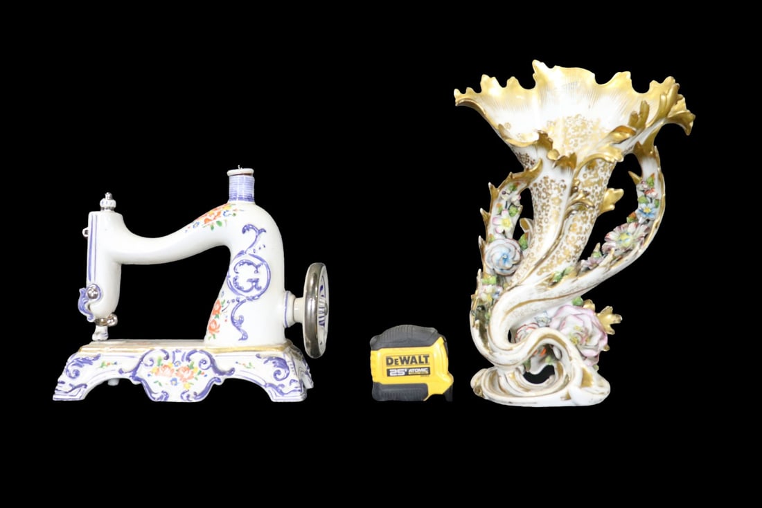 PORCELAIN SEWING MACHINE & PORCELAIN VASE: Marked DC on bottom of vase. Bottom of sewing machine marked Sewing Machine Bottles Beautiful by Cesare 1970 Made in Italy Hand Painted. Porcelain. Painted. One measures 10 1/4" h x 11 1/2" w x 4 1/2"