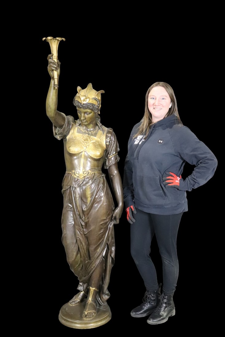 SIGNED E.M.E. CARLIER 2 TONE LIFE SIZE FIGURE LADY HOLDING TORCH: 2 pieces. Bronze. Two tone. Signed EME Carlier on base. 74 1/2" h x 19" w x 23" d.