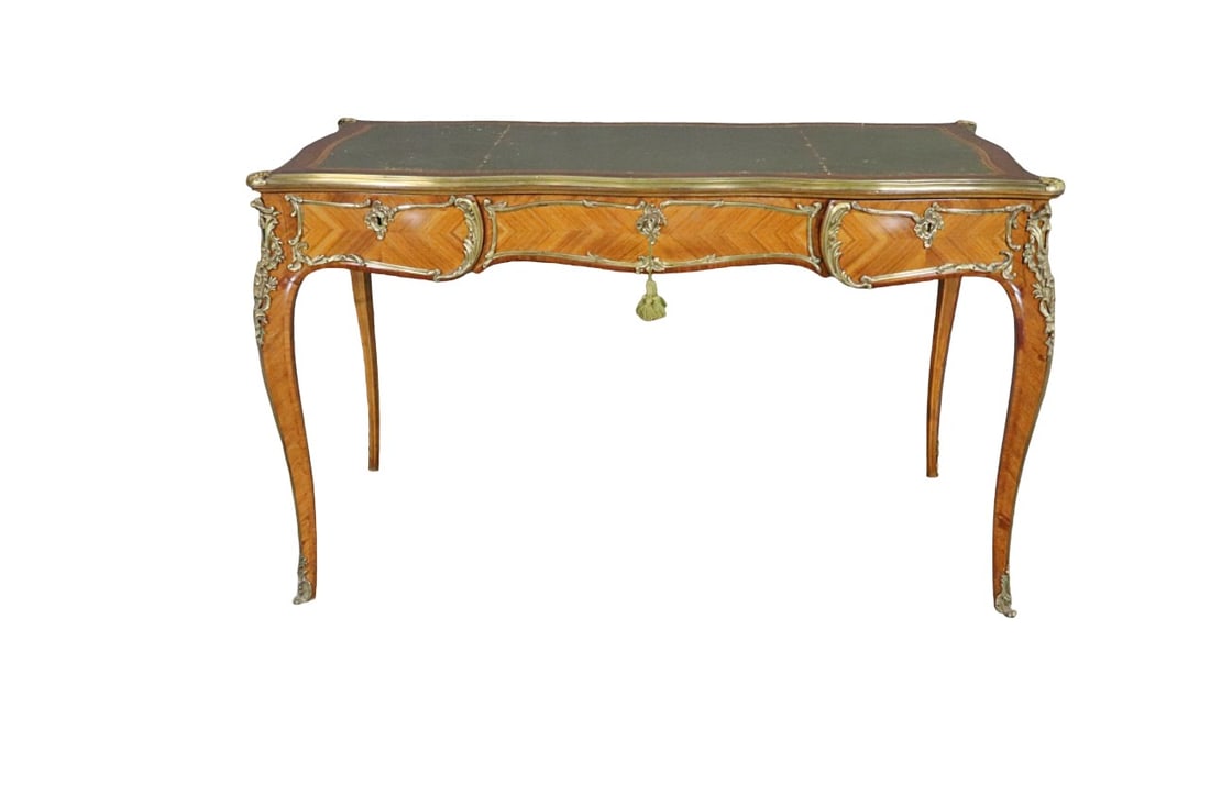 LOUIS XV STYLE BUREAU PLAT WITH LEATHER TOP: Signed Paul Sormani. Leather top. Bronze mounted. 3 drawers. With key. 30" h x 50 1/2" w x 28" d.