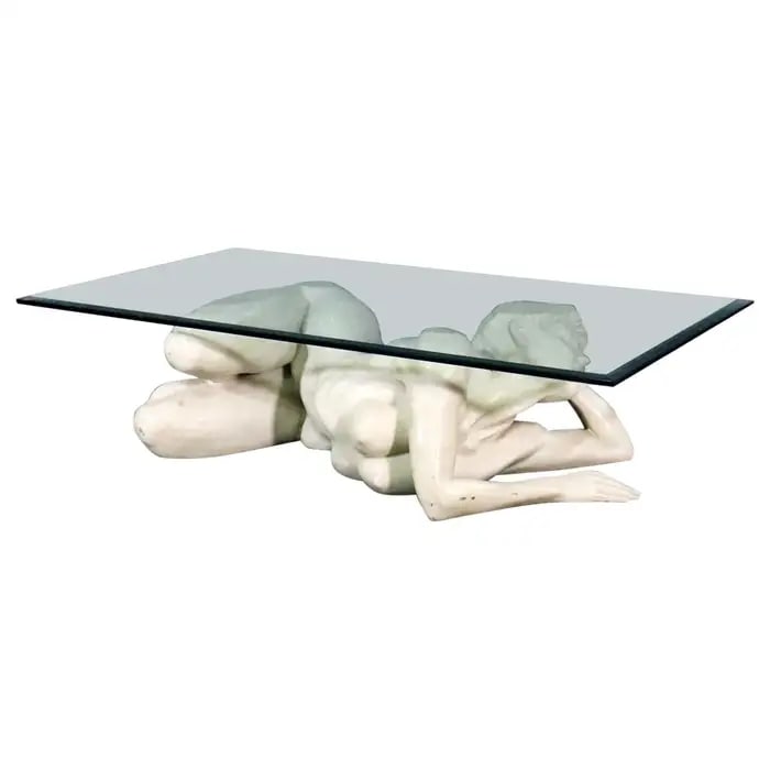 CARVED MARBLE NUDE FIGURAL WOMAN GLASS TOP COFFEE TABLE: Carved marble figural base. Beveled glass top. 14" h x 54 1/2" w x 31" d.