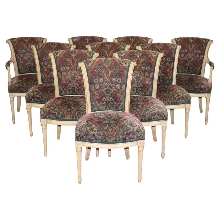10 FRENCH LOUIS XVI SYTLE PAINT DECORATED DINING CHAIRS: Paint decorated. Plush fabric. Carved frames. Fluted legs. Upholstered seats and backs. 2 arm chairs. 8 side chairs. 36 1/4" h x 23" w x 27" d. Seat height 20".