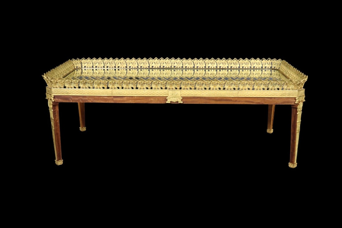 FRENCH LOUIS XVI STYLE GILTWOOD & ORMOLU MOUNTED MIRRORED COFFEE TABLE: Giltwood. Gilded bronze. Mirrored top. 19 1/2" h x 53 /8" w x 28 1/4" d.