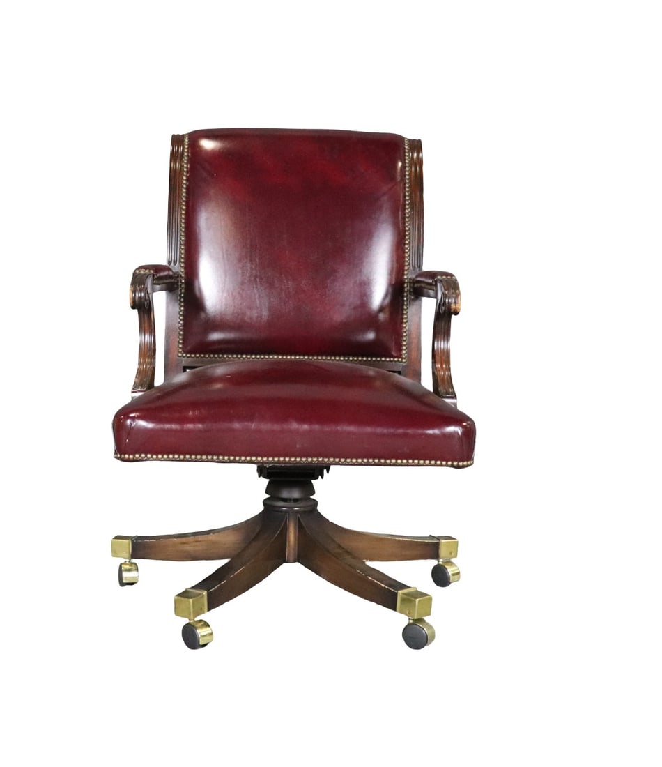 SMITH & WATSON LEATHER SWIVEL OFFICE CHAIR: Leather upholstery. Nail head trim. On casters. Swivels. Wood base with brass foot caps. 39 1/2" h x 26 5/8" w x 31 3/4" d. Seat height 19 1/2".