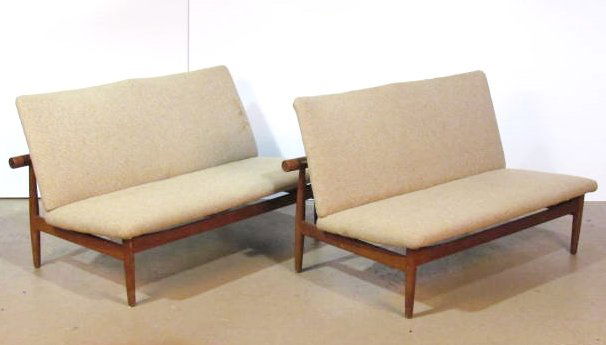 Pair FINN JUHL "JAPAN" TEAK SOFAS: John Stuart metal label. Very good condition. Small chip on end of post. Lightly soiled fabric. 28"h. x 50"w. x 31"d.
