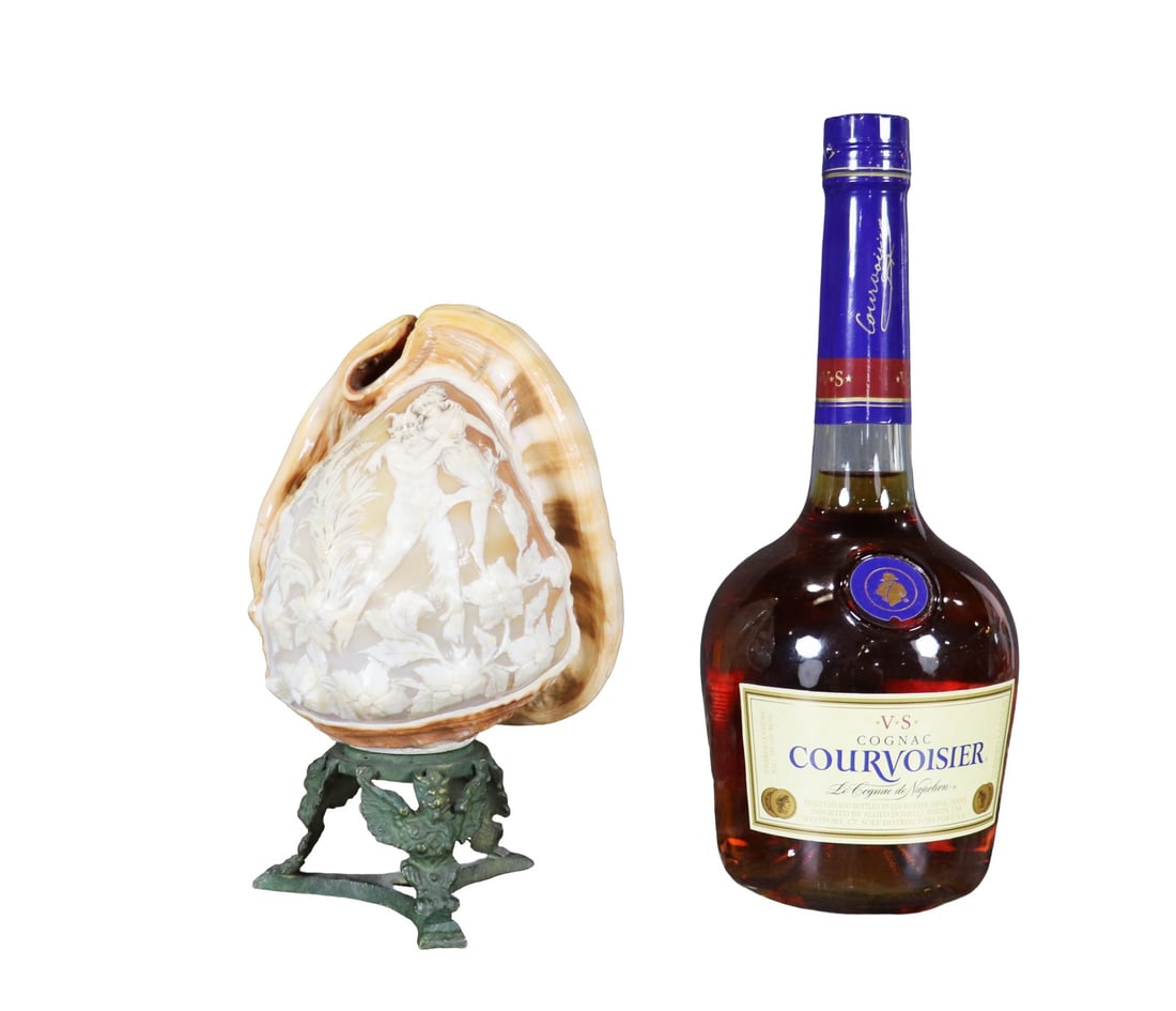 CAMEO SHELL: Conch shell. Metal base. Naples printed on back. 8 3/8" h x 5 1/4" w x 5" d.