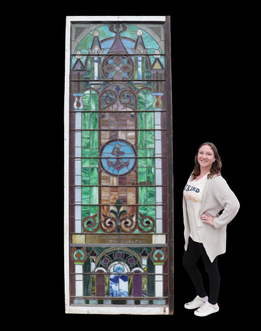 MONUMENTAL STAINED GLASS WINDOW: Wood frame. Stained glass. Metal accents. Painted. 114 1/2" h x 41" w x 1 3/4" d.
