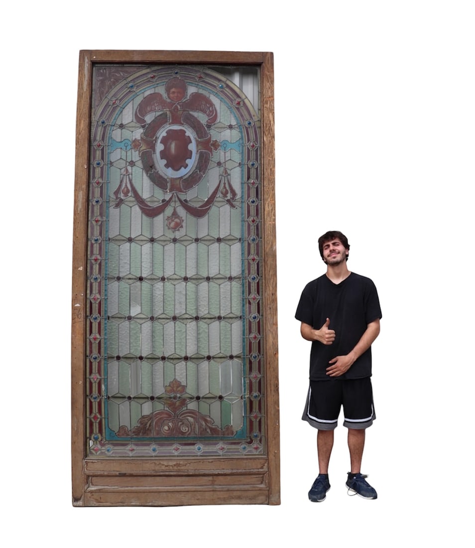 MONUMENTAL STAINED GLASS WINDOW: Stained glass. Wood frame. Metal support bars. 117 1/2" h x 51 3/4" w x 2" d.