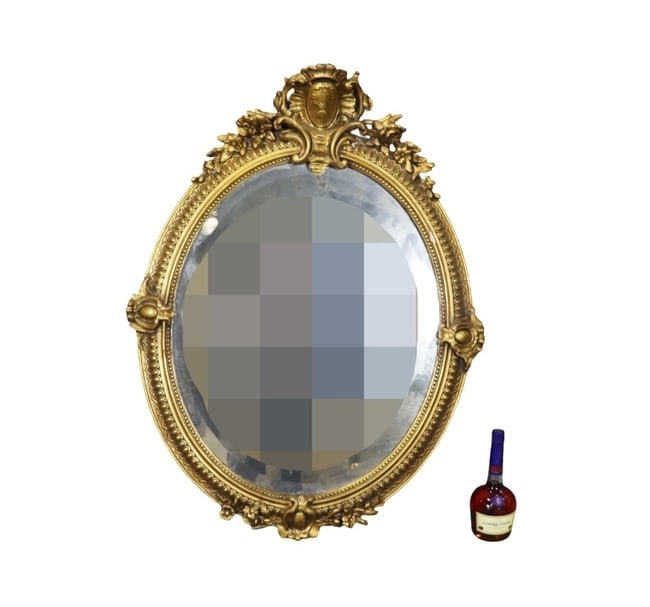 GOLD LEAF CARVED BEVELED GLASS OVAL MIRROR: Carved beveled glass. Gold leaf. Oval. Wood with gesso. 43 1/2" h x 34" w x 6" d.