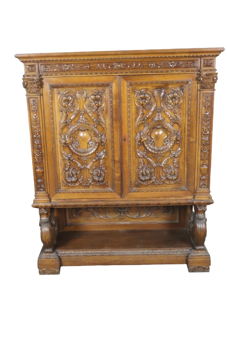 FIGURAL CARVED CHINA MANNER R J HORNER: Carved. Figural. 2 doors containing 3 shelves. 62 1/8" h x 50 3/4" w x 19 1/4" d.