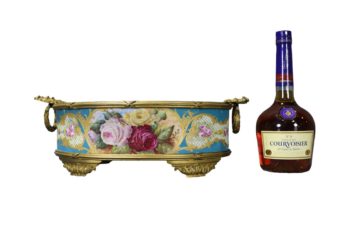 FRENCH SEVRES STYLE BRONZE MOUNTED PORCELAIN CENTERPIECE: Makers mark on bottom. Porcelain. Hand painted. Painting illegibly signed. Gilded bronze ormolu. 5 3/4' h x 16" w x 9 1/2" d.