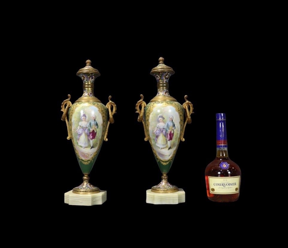PAIR FRENCH SEVRES PORCELAIN URNS: Gilt bronze mounts. Hand painted. Porcelain. Alabaster bases. Sevres mark on back. 18 1/4" h x 7" w x 5 1/4" d.