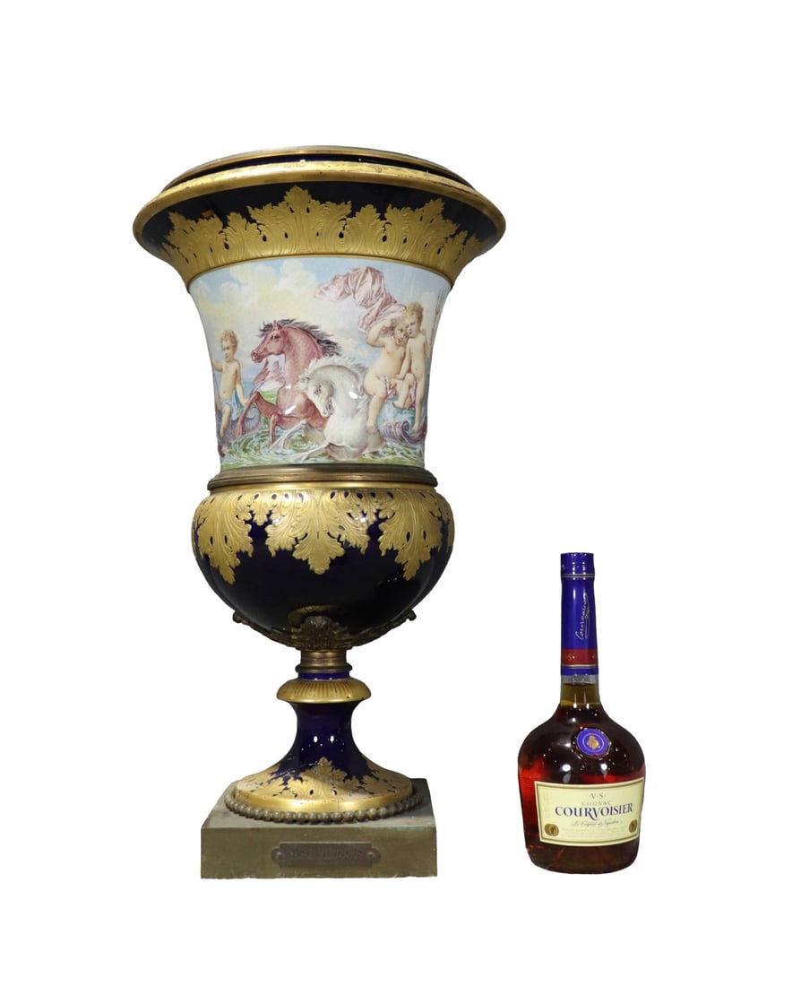 FRENCH SEVRES STYLE PORCELAIN URN: Illegibly signed painting. 2 pieces. Plaque on front reads says Vase Medicis. Chateau Des Tuileries. Porcelain. Hand painted. Gilded metal mounts and base. 23 3/4" x 14 1/4" diameter.