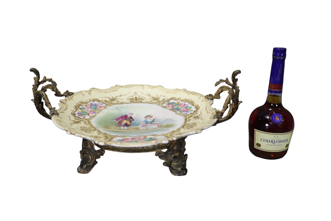 SEVRES PORCELAIN CENTERPIECE BOWL: Sevres mark on bottom. Signed E. Girard on painting. Hand painted. Porcelain. Gilt bronze. 8" h x 19 3/4" w x 15 3/4" d.