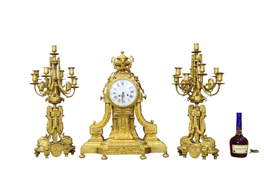 3 PIECE DORE BRONZE CLOCK WITH PAIR CANDLEABRAS: Signed on back of movement DENIERE A PARIS. 3 pieces. 7 arms. Clock measures 25 3/4" h x 21" w x 6 1/2" d. Candelabras measure 26 3/4" h x 13 3/4" w x 10 1/2" d.