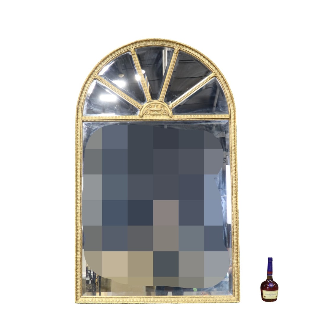 FRENCH REGENCY OVAL TOP GOLD LEAF MIRROR: Gold leaf. Oval top. Beveled glass. 63 1/2" h x 38 5/8" w x 1 5/8" d.