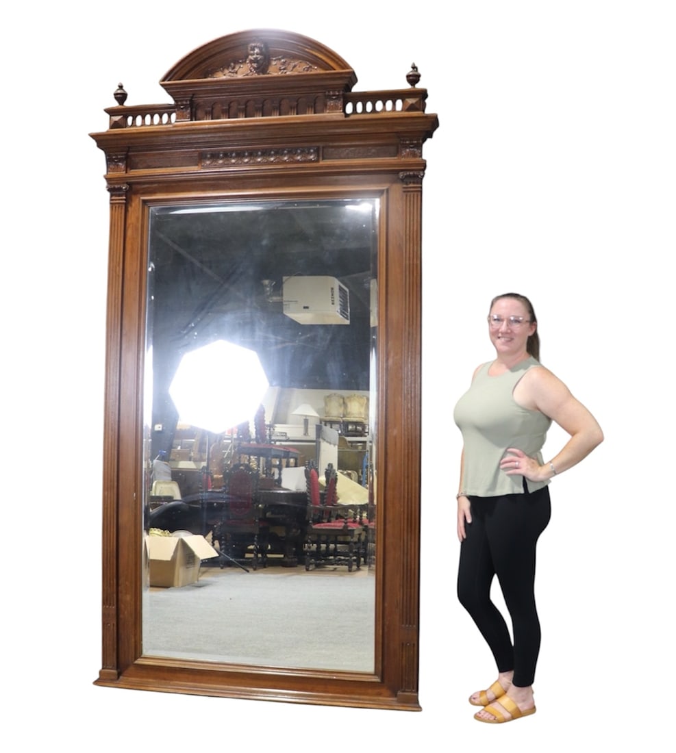 FRENCH CARVED WALNUT FIREPLACE MIRROR: Carved. Walnut. Beveled glass. 99" h x 57 1/2" w x 8" d.