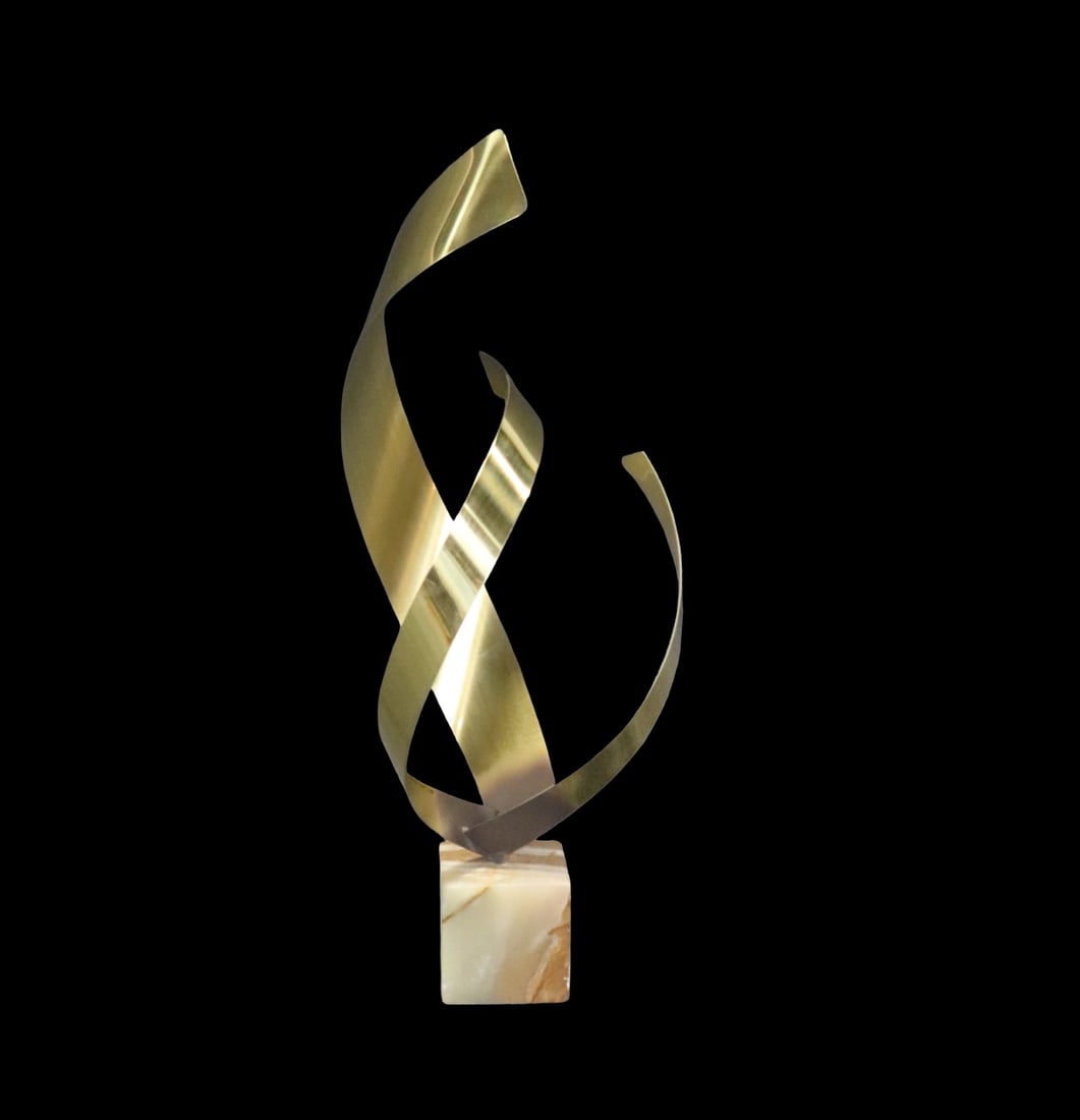 SIGNED CURTIS JERE ABSTRACT BRASS RIBBON SCULPTURE: Signed C. Jere. Brass. Stone base. 27 1/4" h x 9 1/2" w x 10 7/8" d.