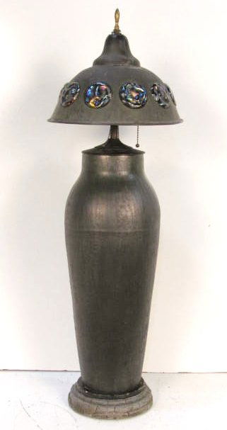 FULPER ART POTTERY LAMP w/ ARTS & CRAFTS SHADE: Green mottled glaze. Vase drilled. Bronze shade with iridescent art glass inserts. Two inserts missing. Vase measures 23 1/2"h. Lamp measures 39 1/2"h.