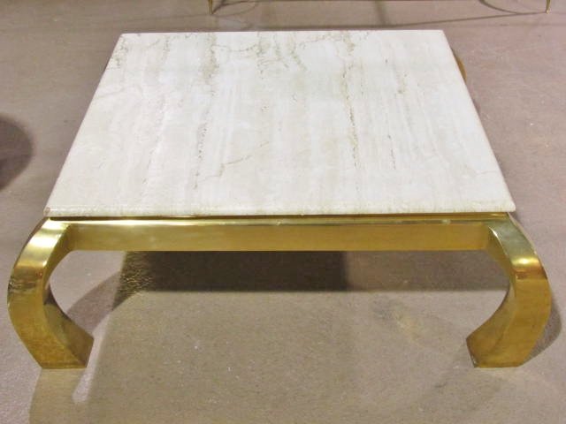 SPRINGER STYLE MODERN BRASS & TRAVERTINE COCKTAIL TABLE: Solid brass frame topped by a travertine top. Very good condition. 15 1/2"h. x 44"sq.