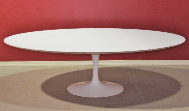 EERO SAARINEN for KNOLL TULIP BASE OVAL TABLE: Good condition. Some wear to laminate top and base. 29"h. x 95 3/4"w. x 53 3/4"d.