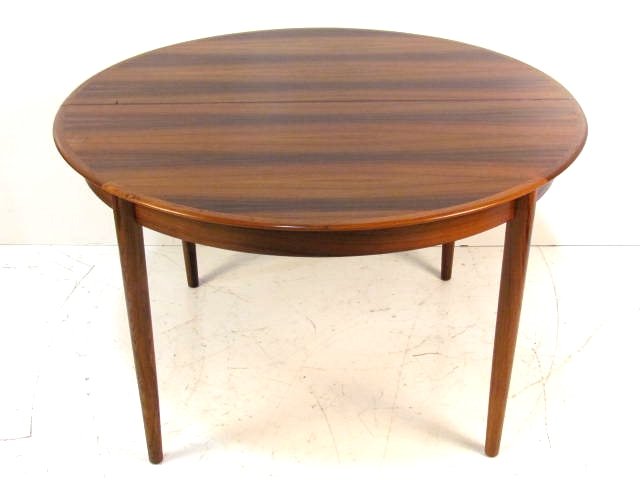 ARNE VODDER ROSEWOOD DINING TABLE w/ 3 BOARDS: Very good condition. 28 1/2"h. x 47 1/4"diam. Three 20"w. boards.
