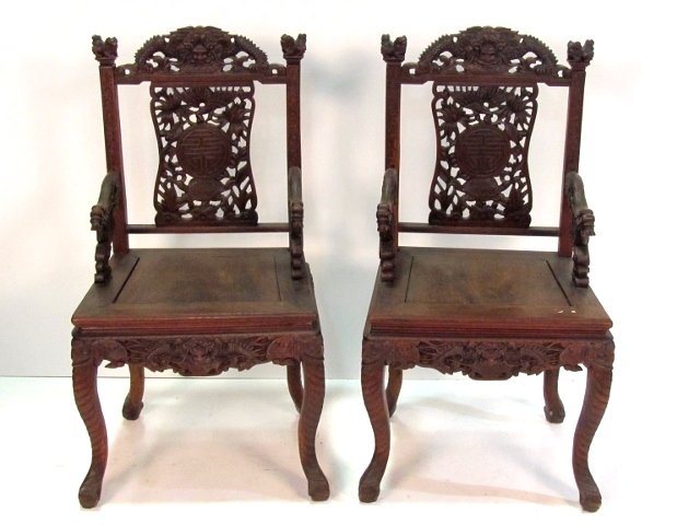 Pair CHINESE CARVED TEAK WOOD ARMCHAIRS: Carved foo dogs and dragons. Very good condition. 38"h. x 21"w. x 17"d.