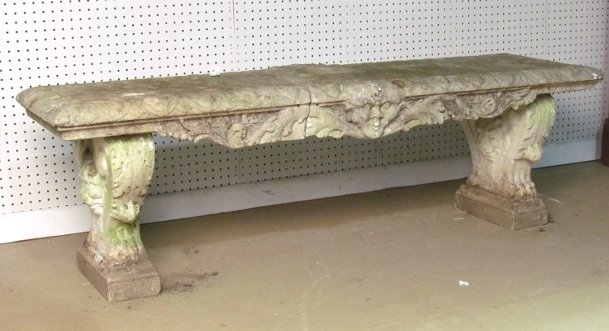 18th c. ITALIAN CARVED MARBLE GARDEN BENCH: Carved lions heads and northwind faces. Weathered. Cracked top. 18 1/2"h. x 61 1/2"w. x 18"d.