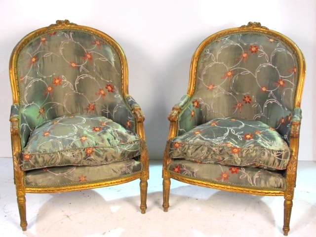 Pair LOUIS XVI STYLE CARVED BROQUETED GILT BERGERES: Distress gilt with wear. Very good condition. 40 1/2"h. x 30"w. x 25 1/2"d.