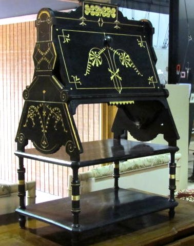 VICTORIAN EBONIZED & GILT MAGAZINE RACK: Ebonized with gilt incising. Spring mechanism. Good condition. 38 1/2"h. x 25"w. x 17"d