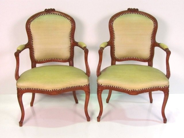 Pair LOUIS XV STYLE CARVED WALNUT FAUTEUILS: Vinyl upholstery. Seam cracking on top of 1 chair. Very good condition. 38"h. x 26 1/4"w. x 23"d.