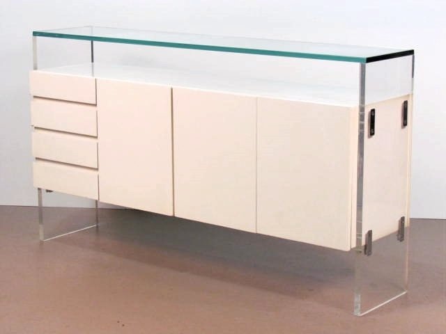 MILO BAUGHMAN THAYER COGGIN LUCITE SIDEBOARD: Laminate with lucite sides. Glass top. Some minor edge damage on door. Good condition. 36 1/2"h. x 64 1/2"w. x 16"d.