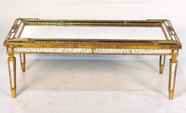 ITALIAN GILT CARVED MIRRORED COFFEE TABLE: Few cracked mirror panels. Very good condition. 19"h. x 48"w. x 20"d.