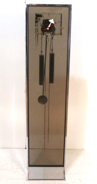 HOWARD MILLER CHROME & LUCITE GRANDMOTHER CLOCK: Good condition. Not presently working. 56"h. x 13"w. x 2 1/2"d.