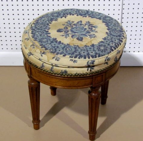 LOUIS XVI STYLE NEEDLEPOINT SWIVEL FOOTSTOOL: Swivels. Soiled upholstery. 17 1/2"h. x 17"diam.