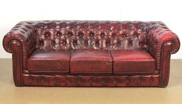 ENGLISH RED TUFTED LEATHER CHESTERFIELD SOFA: Distressed leather with wear. Very good condition. 28"h. x 84"w. x 38"d.