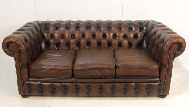 TUFTED BROWN LEATHER CHESTERFIELD SOFA: Distressed leather with light wear. Tear on side panel. Very good condition. 29"h. x 73"w. x 36"d.