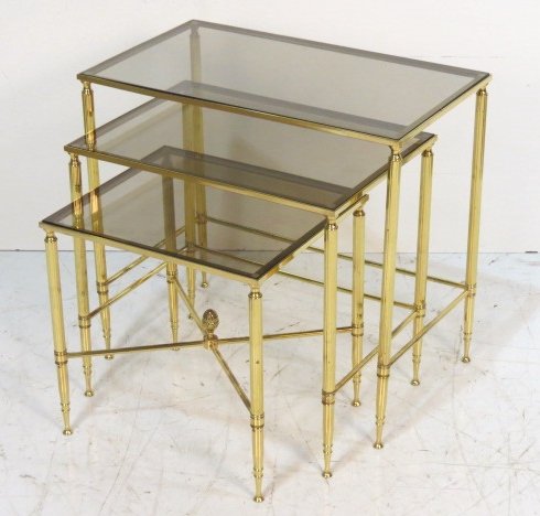 SET of 3 BRASS DIRECTOIRE STYLE NESTING TABLES: Smoked glass top. Very good condition with some pitting to metal. 22 1/4"h. x 24"w. x 14"d.