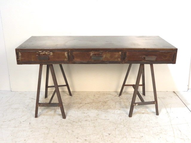 INDUSTRIAL DESIGN CAMPAIGN STYLE SAWHORSE DESK: Intentional wear and surface rust. Good condition. 32"h. x 57 1/4"w. x 24"d.