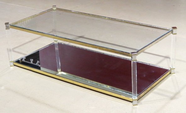 MODERN LUCITE & GLASS COFFEE TABLE: Glass top with some minor edge chips. Mirror shelf. Light scratches on lucite. Good condition. 16 1/2"h. x 54 1/4"w. x 26 1/2"d.