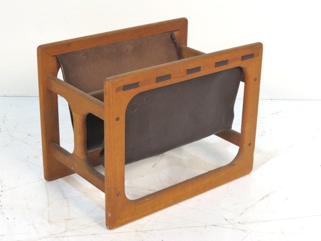 DANISH MODERN TEAK & LEATHER MAGAZINE RACK: Torn leather. Mildew odor. Fair condition. 16"h. x 20 1/2"w. x 13"d.