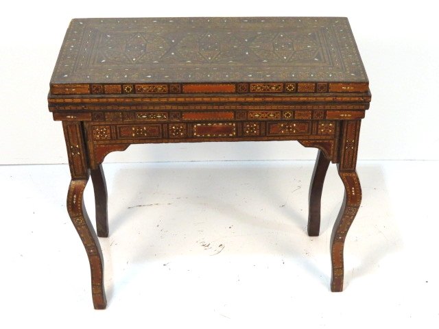 ANTIQUE MOORISH INLAID GAME TABLE: Inlaid woods and mother of pearl. Various small damages. Good condition. 31 1/2"h. x 33 3/4"w. x 17"d.