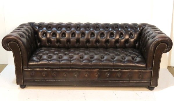 BROWN LEATHER CHESTERFIELD SOFA: Minor surface scratching. Very good condition. 27"h. x 76"w. x 33"d.
