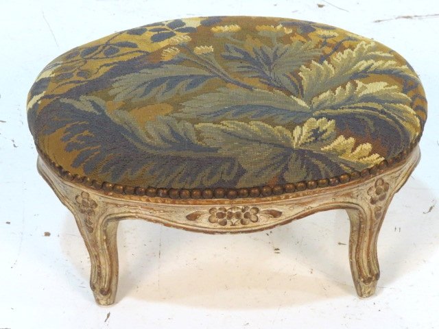 FRENCH STYLE DISTRESSED PAINTED TAPESTRY OVAL FOOTSTOOL: Distressed cream paint. Very good condition. 9"h. x 15 1/2"w. x 8 1/2"d.