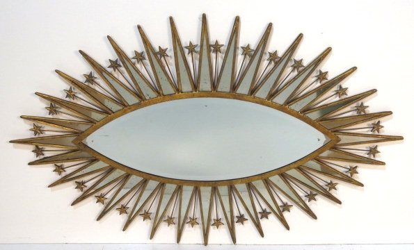 ELLIPTICAL GILT METAL STARBURST MIRROR: Beveled glass. Very good condition. 34 1/2"h. x 54 1/2"w.