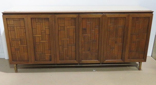 JOHN STUART MID CENTURY TRAVERTINE TOP SIDEBOARD: Walnut with sculptural doors. Travertine marble top. 33"h. x 72"w. x 20 1/4"d.