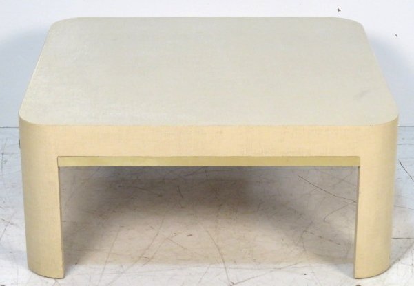 KARL SPRINGER STYLE PAINTED BURLAP WRAPPED TABLE: Cream painted burlap with brass mouldings. 16"h. x 37"w. x 35"d.