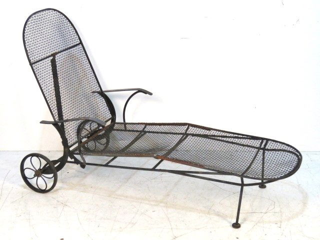 MID CENTURY IRON PATIO CHAISE LOUNGE: Black painted iron. 40 1/2"h. x 25 1/2"w. x 77"d.