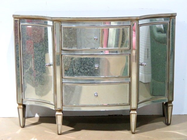 SERPENTINE FRONT MIRRORED COMMODE: Distress silvered beveled mirror panels and silvered wood trim. 34 3/4"h. x 48 1/4"w. x 20"d.